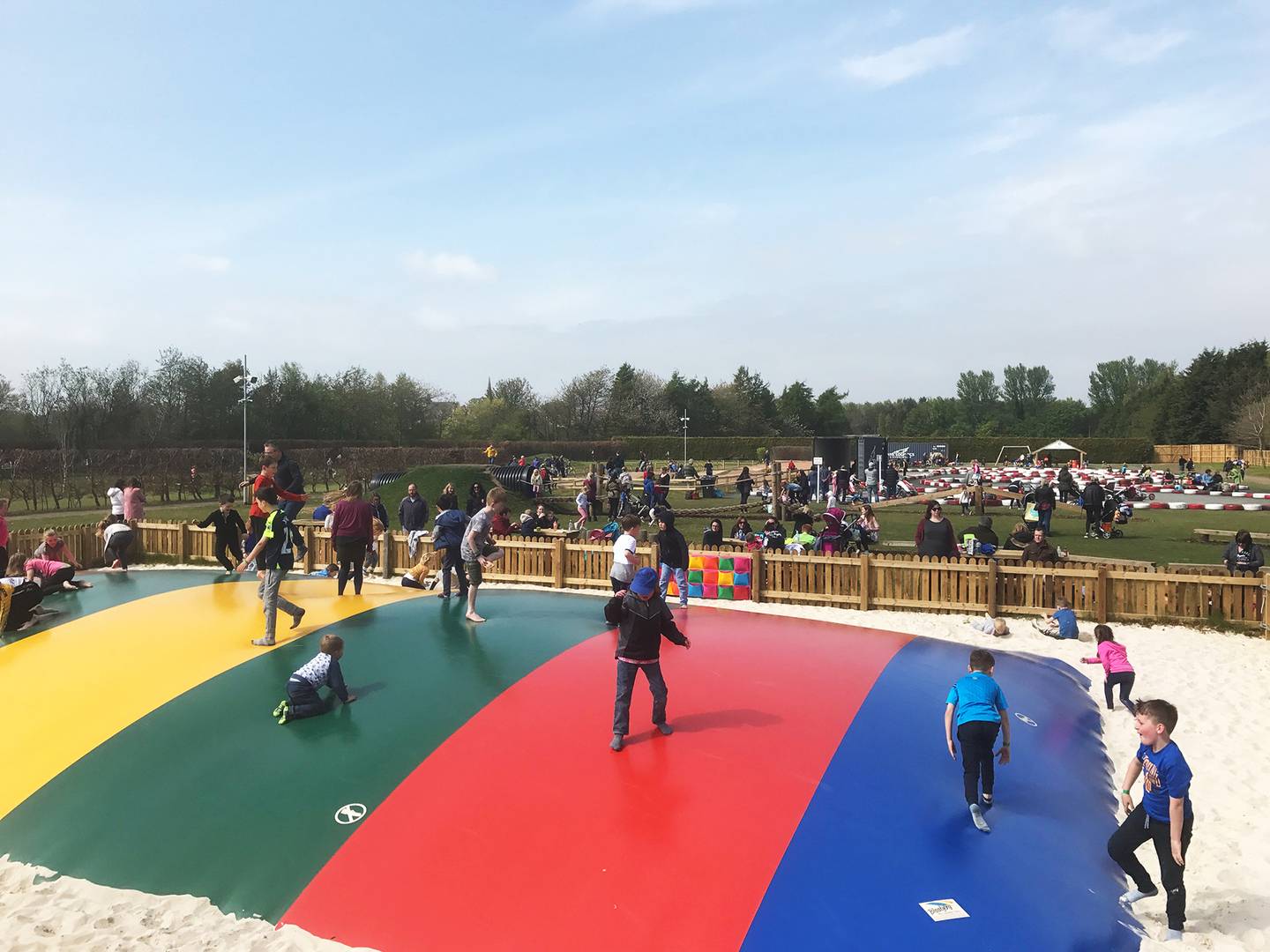 Conifox Adventure Park with people bouncing on giant colourful bouncy pillow