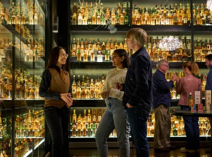 Tour guide and visitors within the whisky collection,© The Scotch Whisky Experience