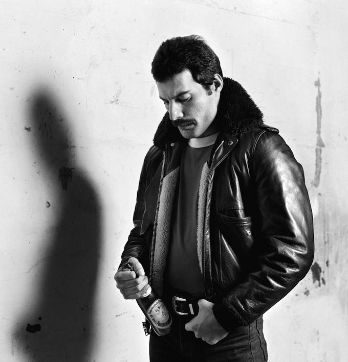 Freddie Mercury in leather jacket holding bottle of German beer,© Peter Hince