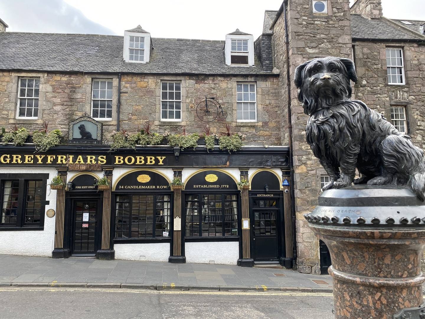 Greyfriars Bobby Statue with Greyfriars Bobby pub in background