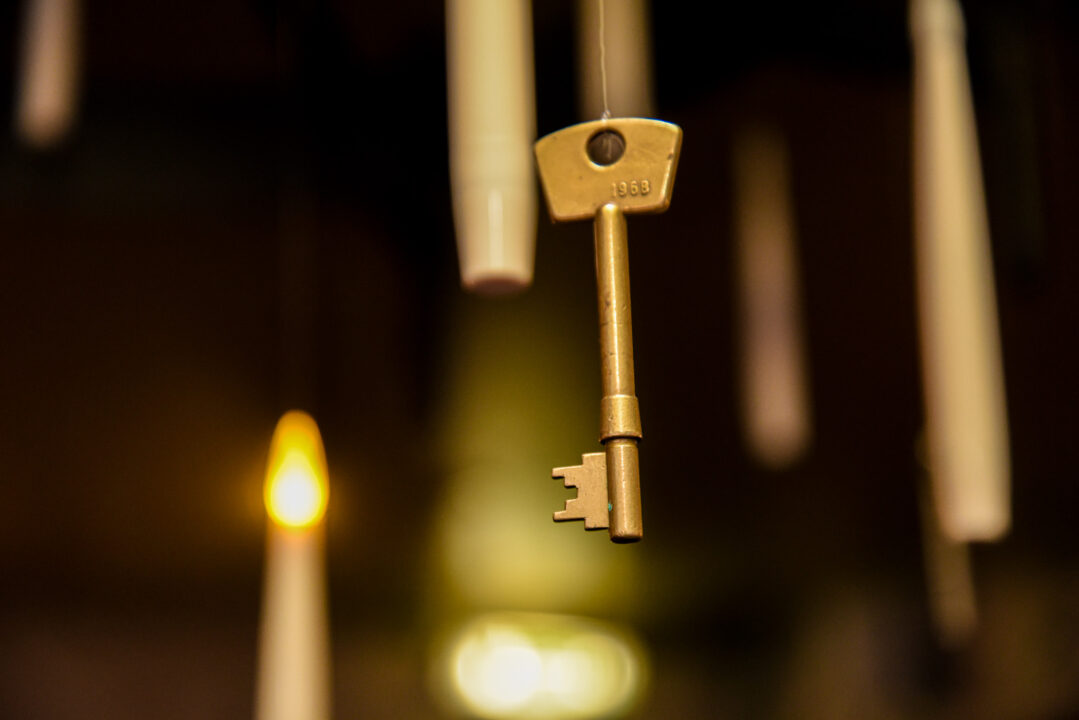 Floating candle sticks surrounding a key.