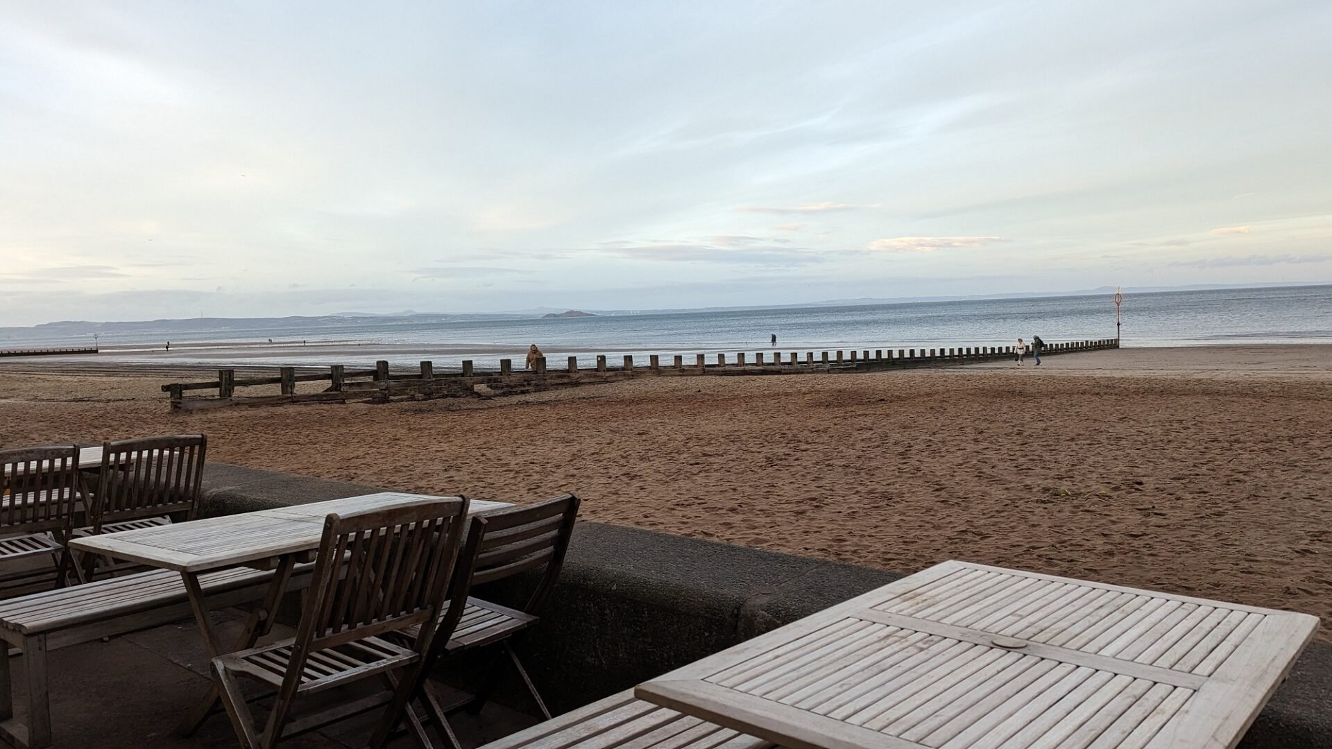 Beach House cafe tables overlooking Portobello sandy beach and sea as backdrop
