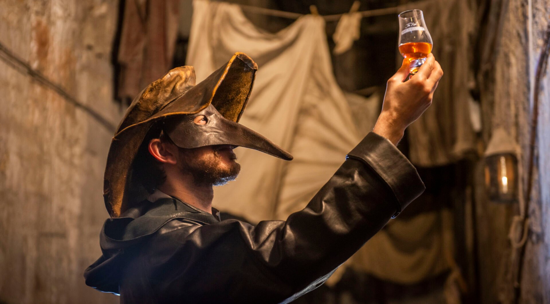 Tour guide with dram of whisky at The Real Mary Kings Close