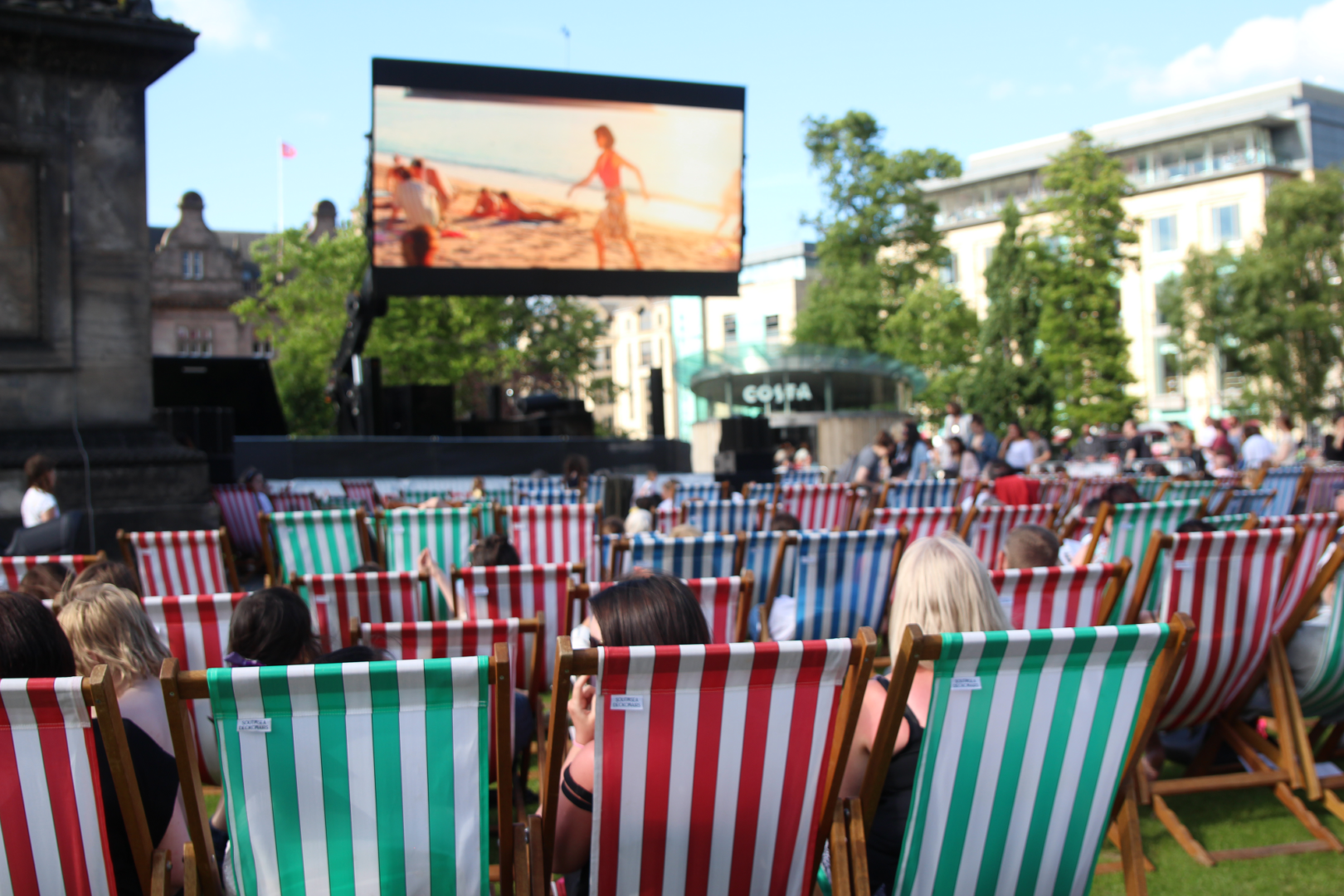 People sitting on Deck Chairs at Square Cinema