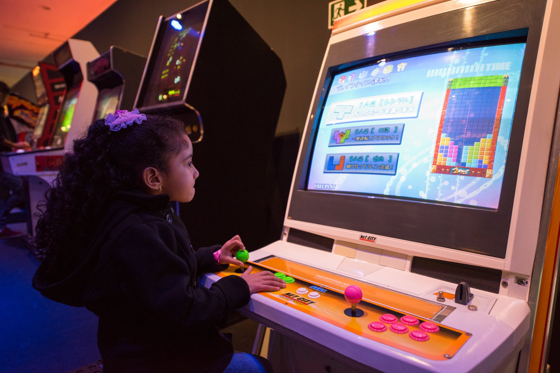 Girl playing Tetris on computer during Game on Exhibition.