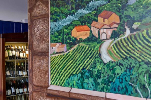 Wine cabinet and a wall mural at la garrigue