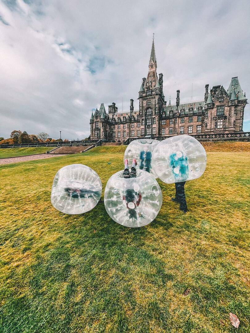 Children in Zorb balls in front of Stewart Melville School with the Wild Outdoors,© The Wild Outdoors