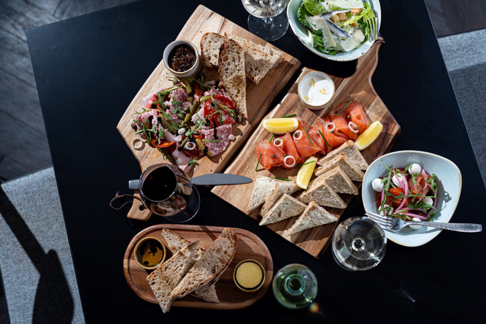 Platter on table of sandwiches and meats.