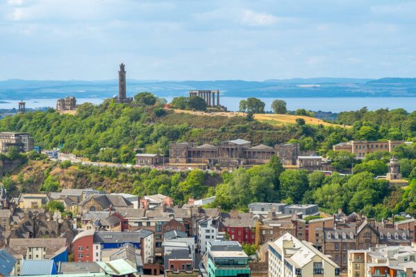 View of Edinburgh featuring the Nelson Monument. Includes the skyline, surrounding trees and sea.