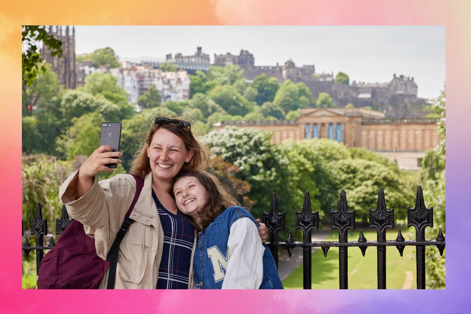 Lady and Daughter taking a picture with National Galleries and Castle in background.