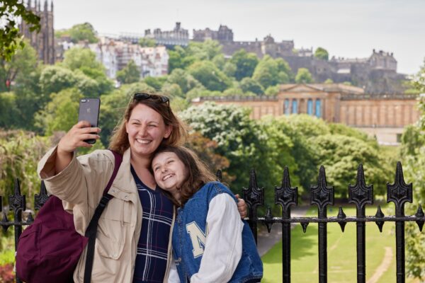 Mother and Daughter taking photo with National Galleries and Castle in Background