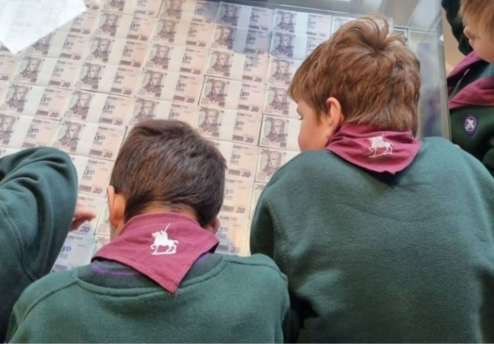 A rear view of Cubs in uniform looing at one million pounds