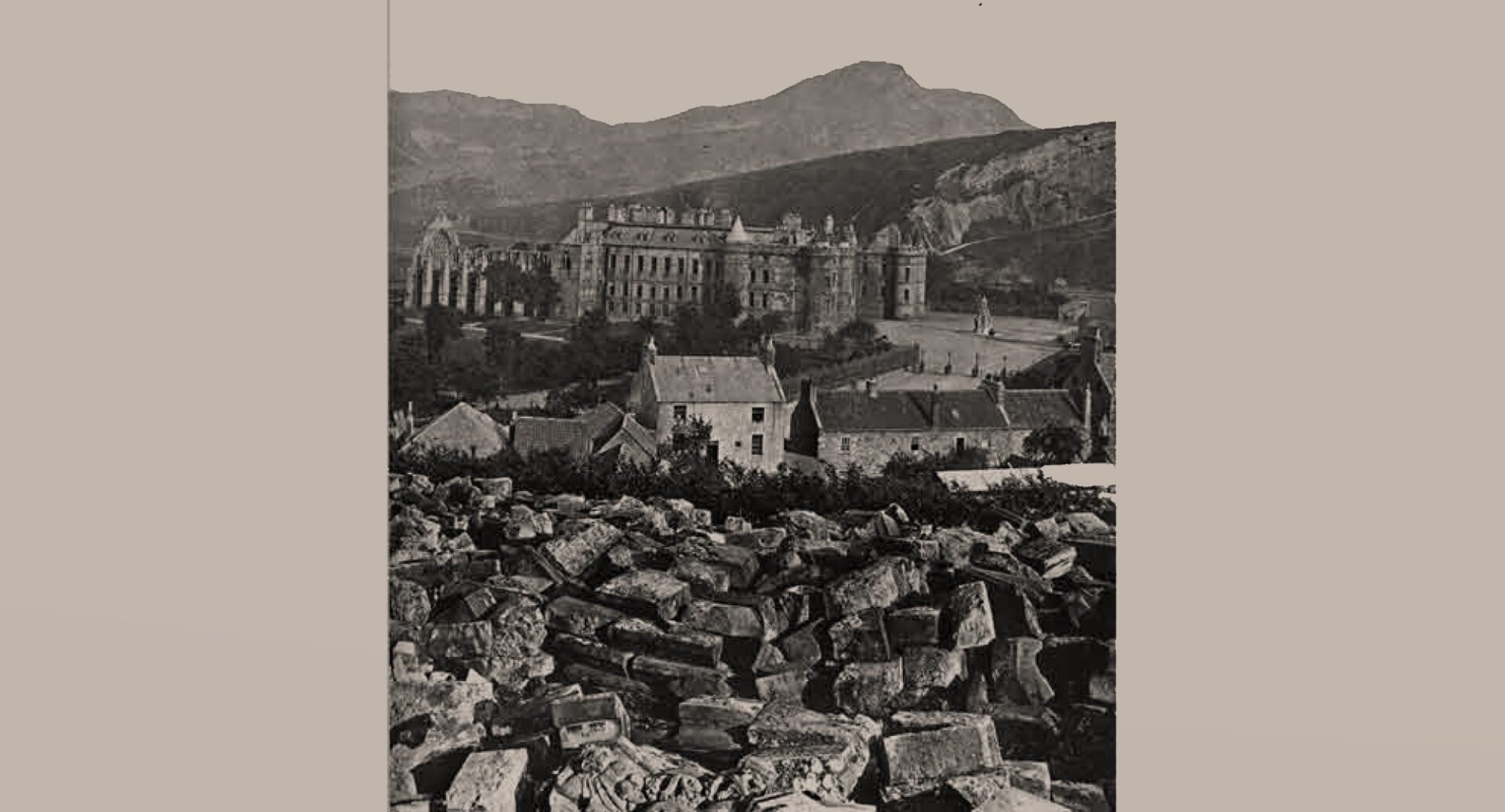 A photograph of the remains of the Trinity Stones lying in Calton Hill, with buildings and the Crags in the background