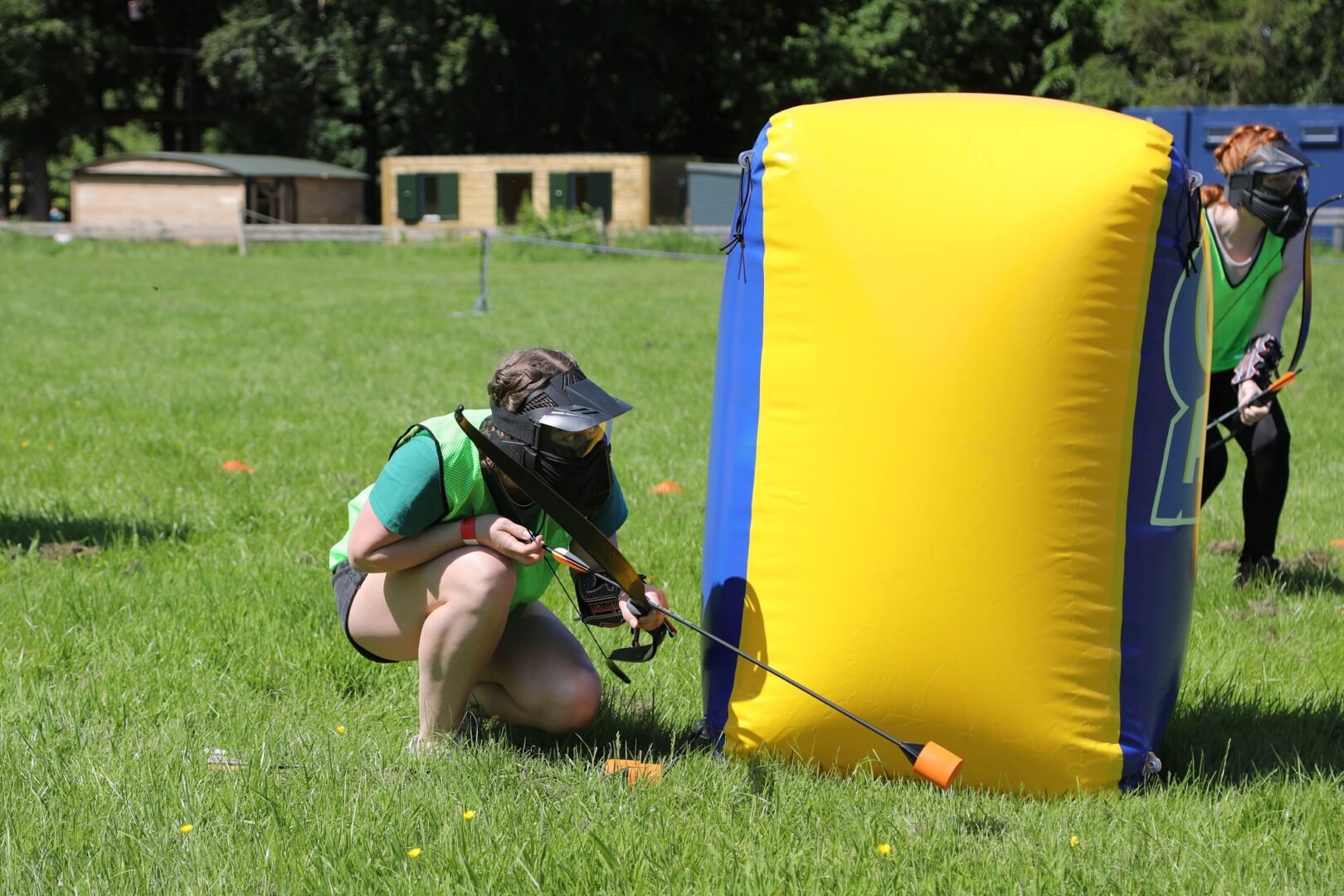 Archery Tag player hiding behind inflatable