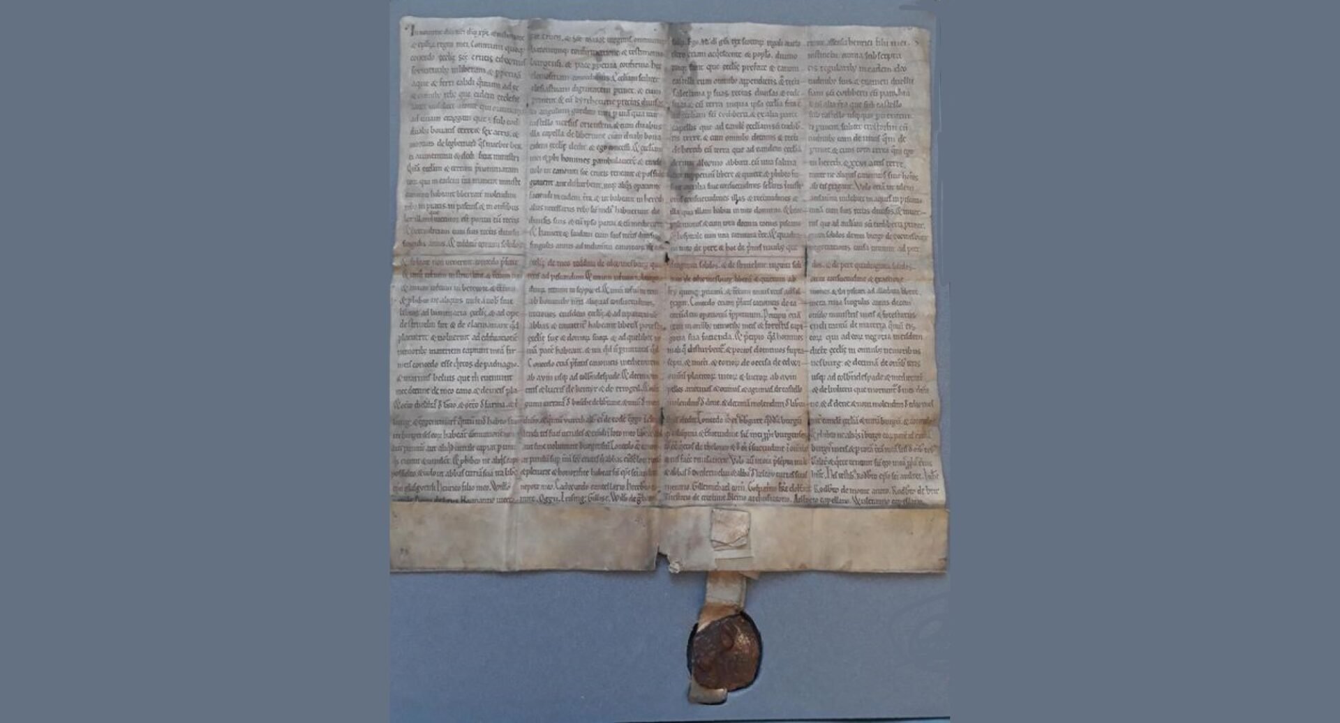 The charter with mediaeval writing and a seal at the bottom