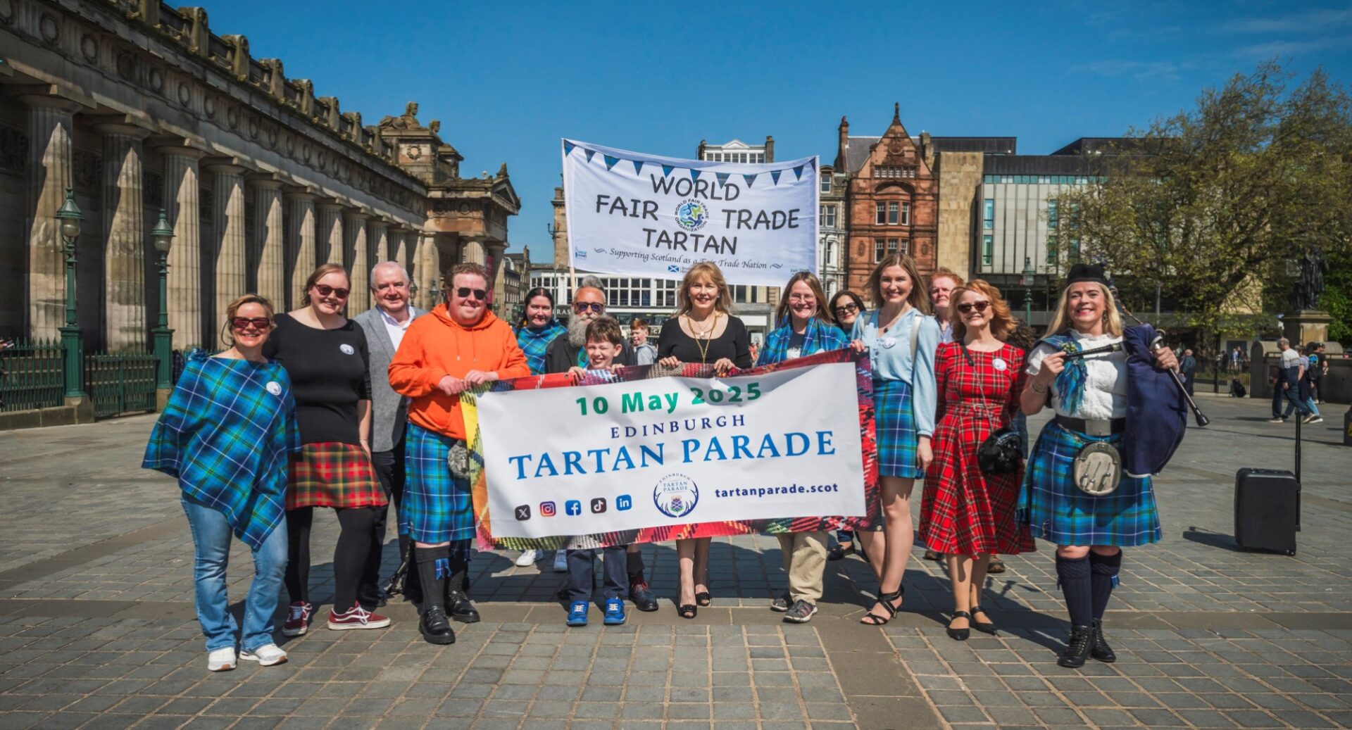 A group of people at the Mount Precinct holding a banner for the Tartan Parade