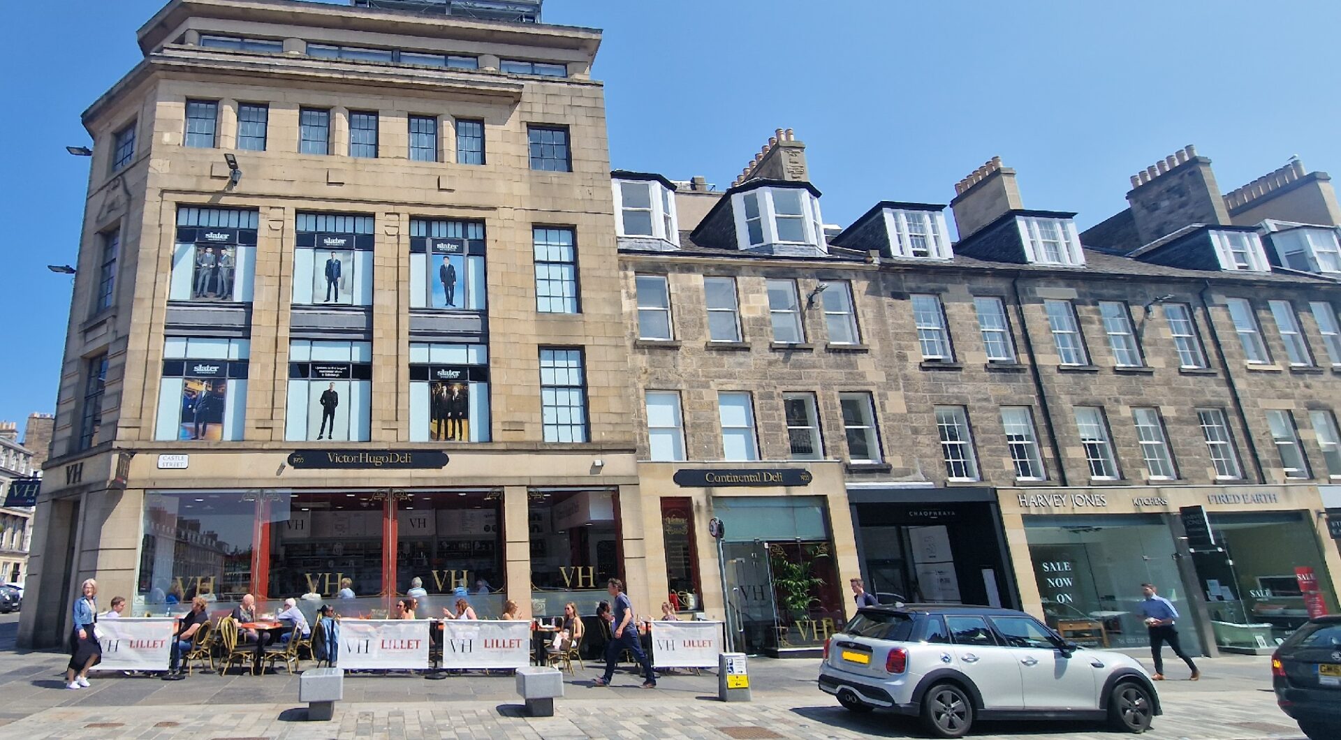 People sitting eating and drinking outside Victor Hugo on Castle Street