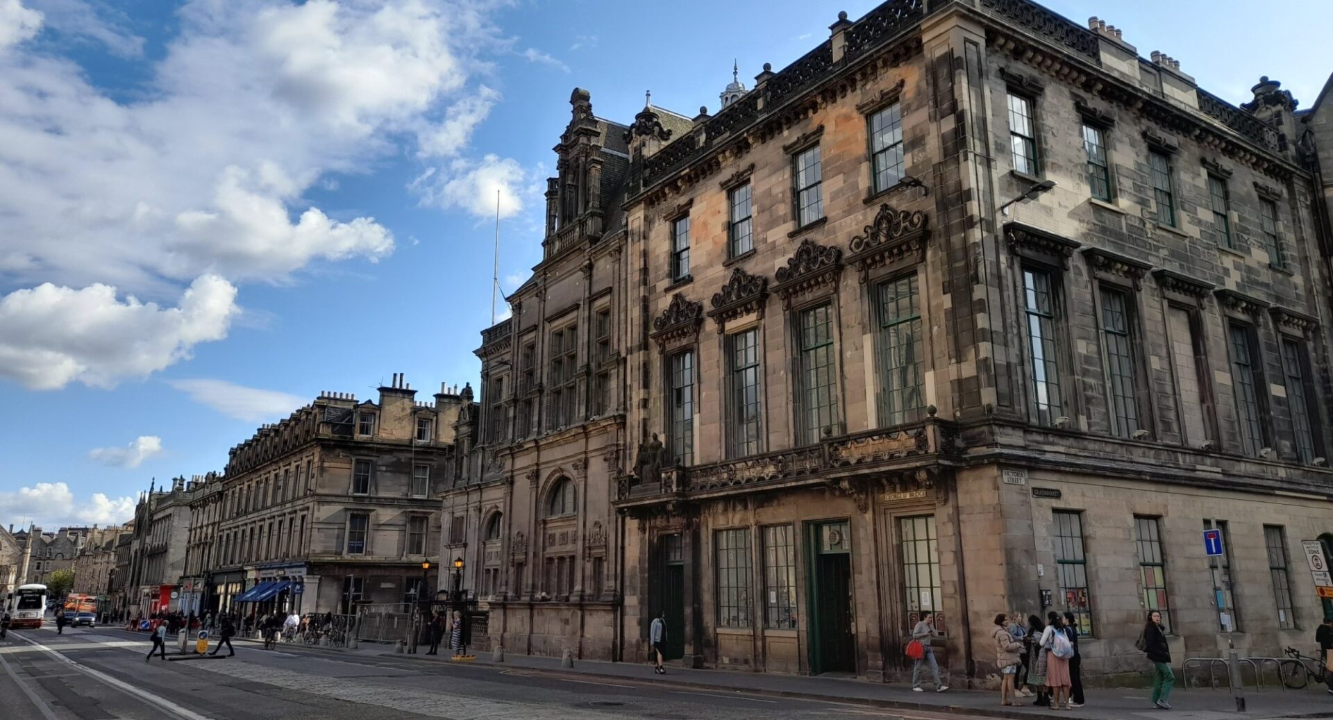 An external shot of Central Library from the far side of George IV Bridge, showing pedestrians and passing traffic