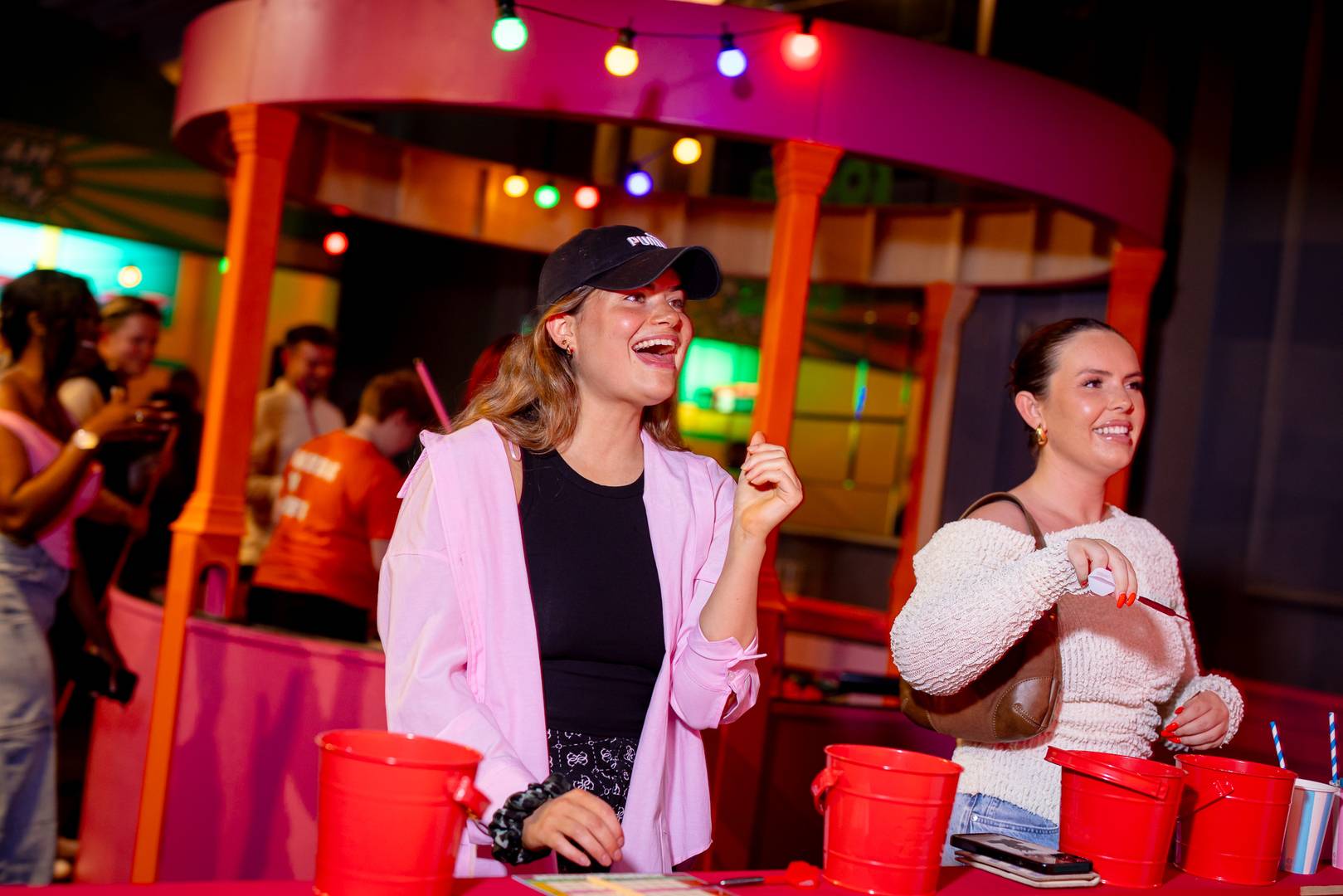 Two ladies having fun playing fairground games