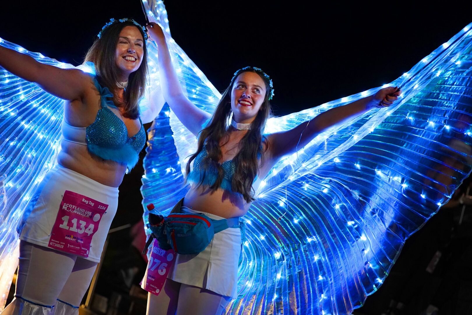 two ladies with angel wings with lights as part of their costume for the Moon Walk