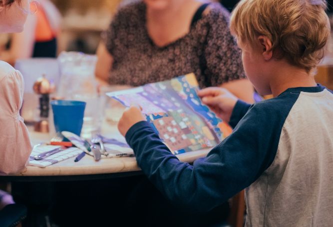 Child looking at the kids menu at Brewhemia