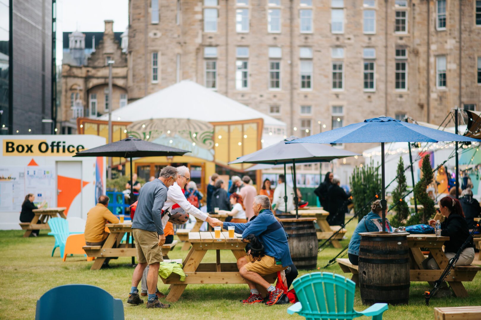 People sitting at picnic benches