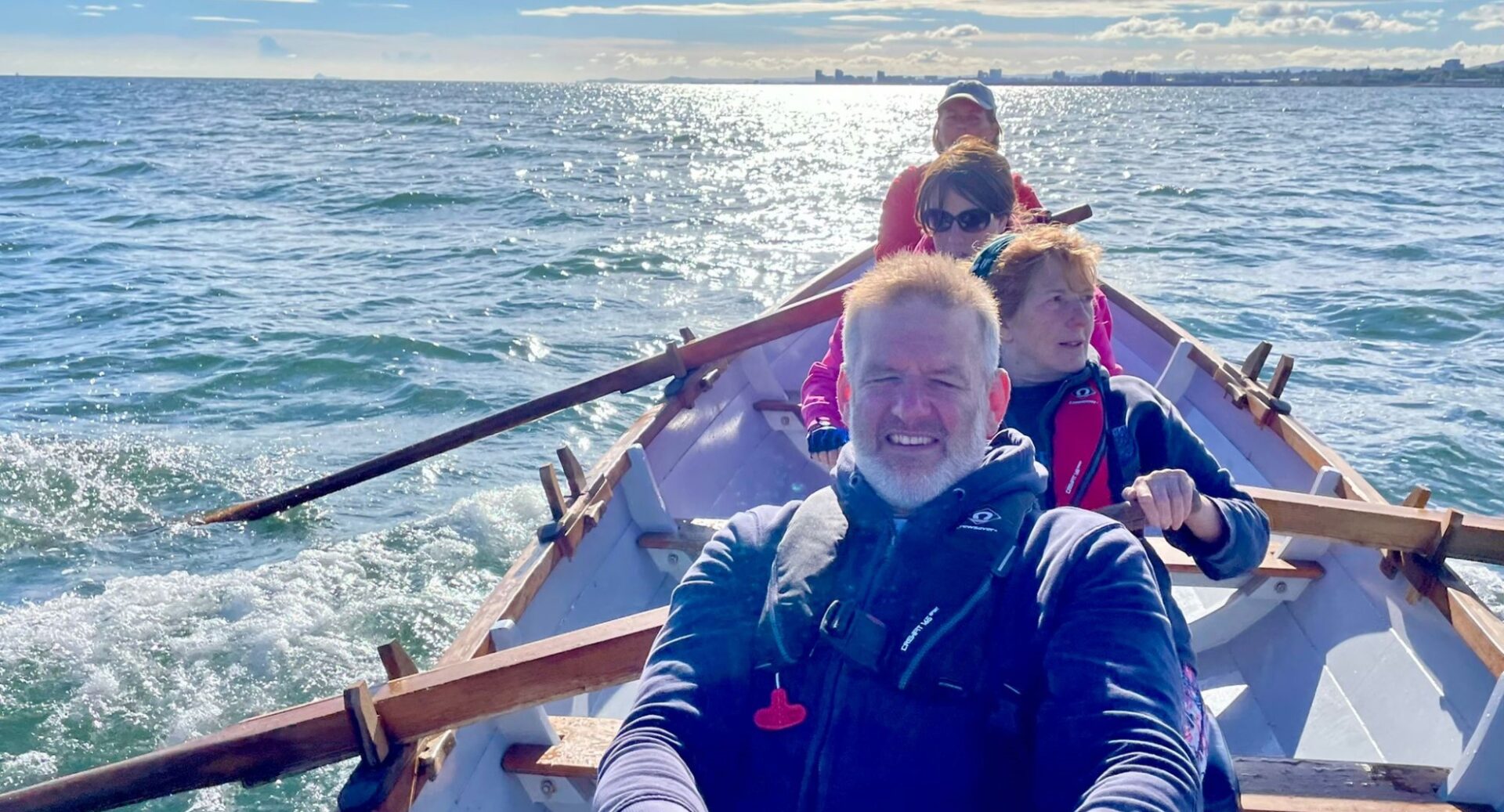 A shot of rowers on the Forth on a sunny day