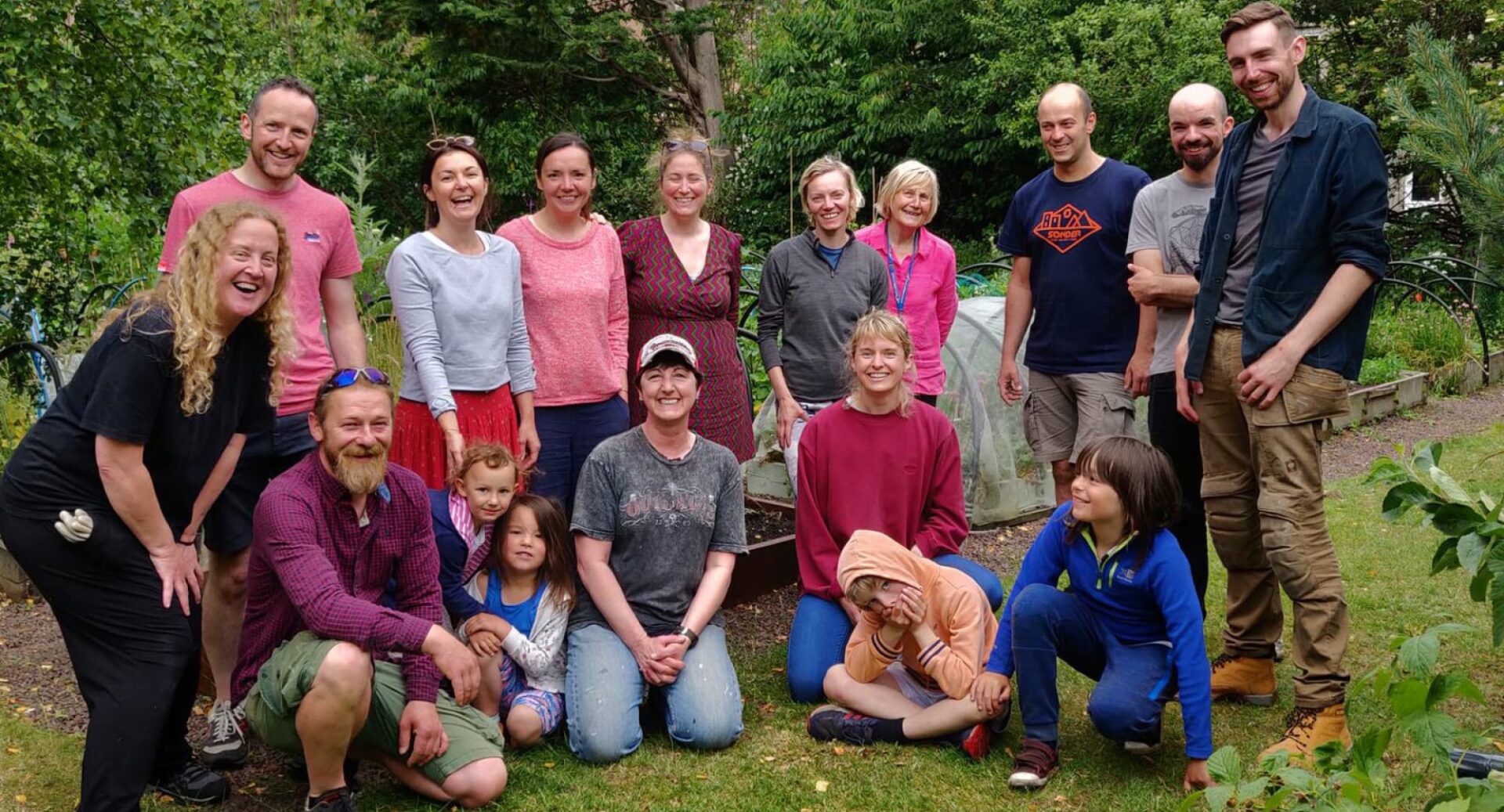 A group of tool library users photographed against a backdrop of trees