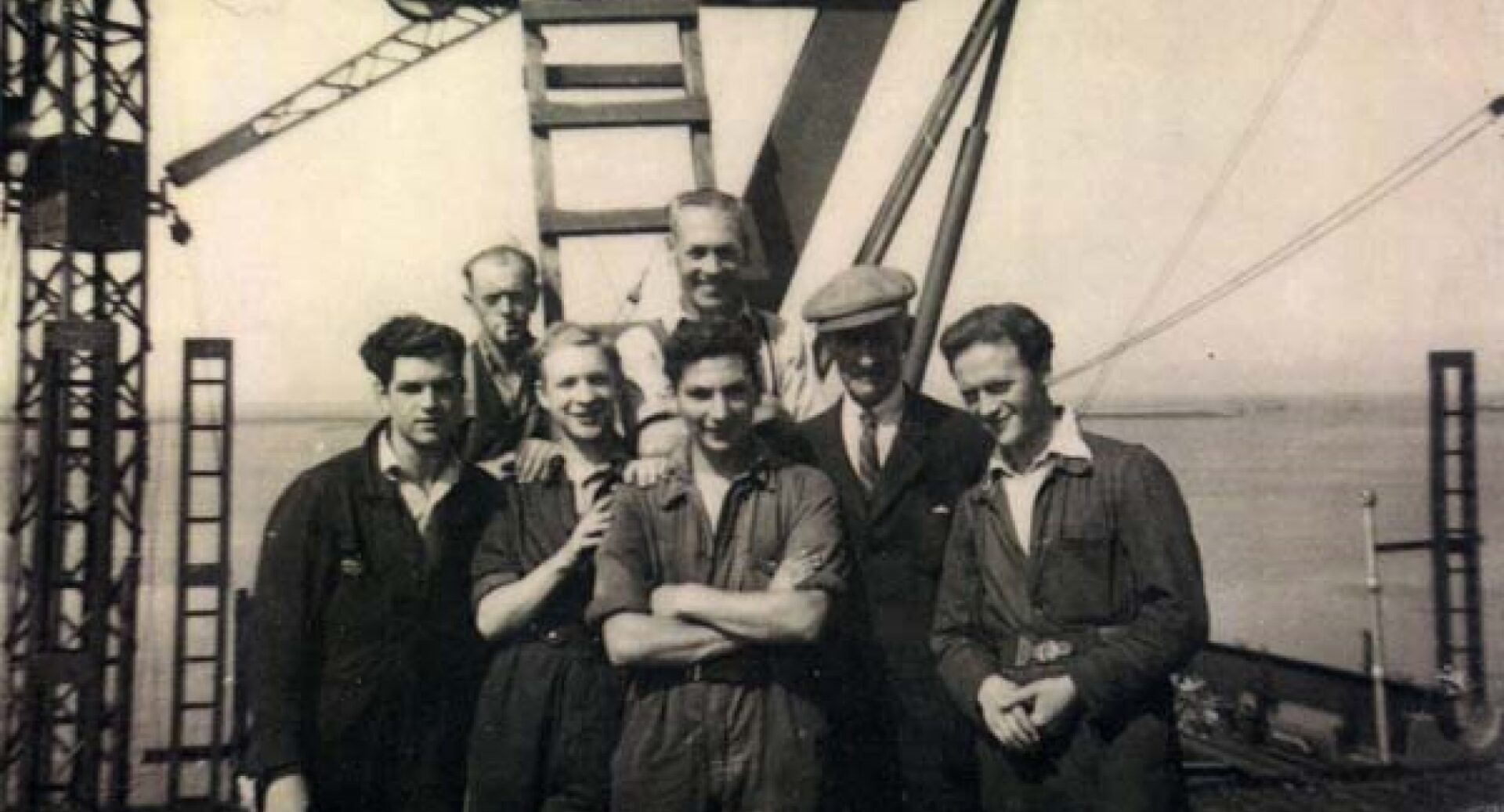 A black and white photo of seven Henry Robb apprentices in their overalls in the 1940s