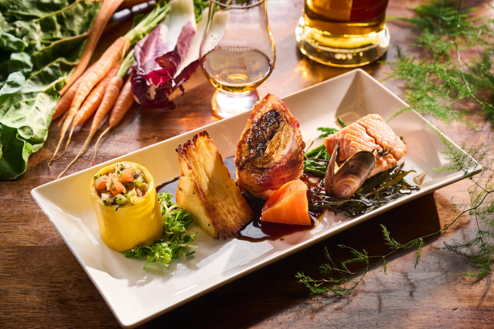 Main course with raw ingredients in background at Amber Restaurant