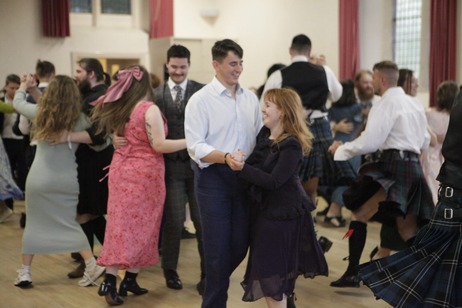 Room of people ceilidh dancing