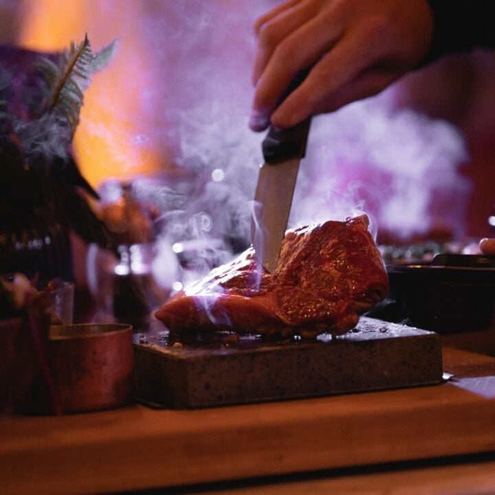 steak with a knife cutting it.