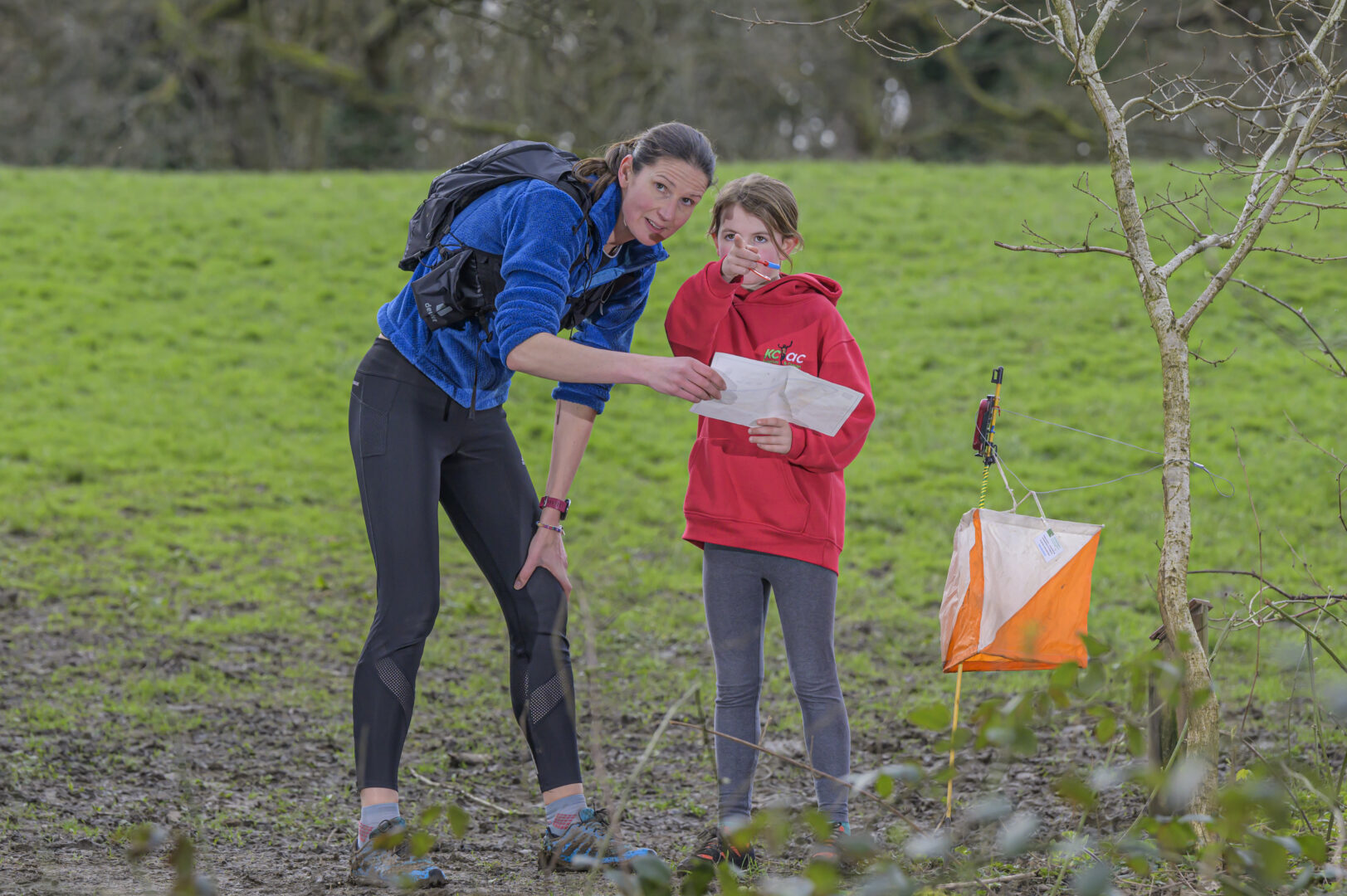 Women and young child navigating orienteering course.