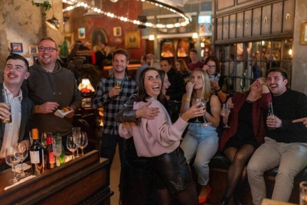 A group of people celebrating while playing Social Darts in Flight Club Edinburgh