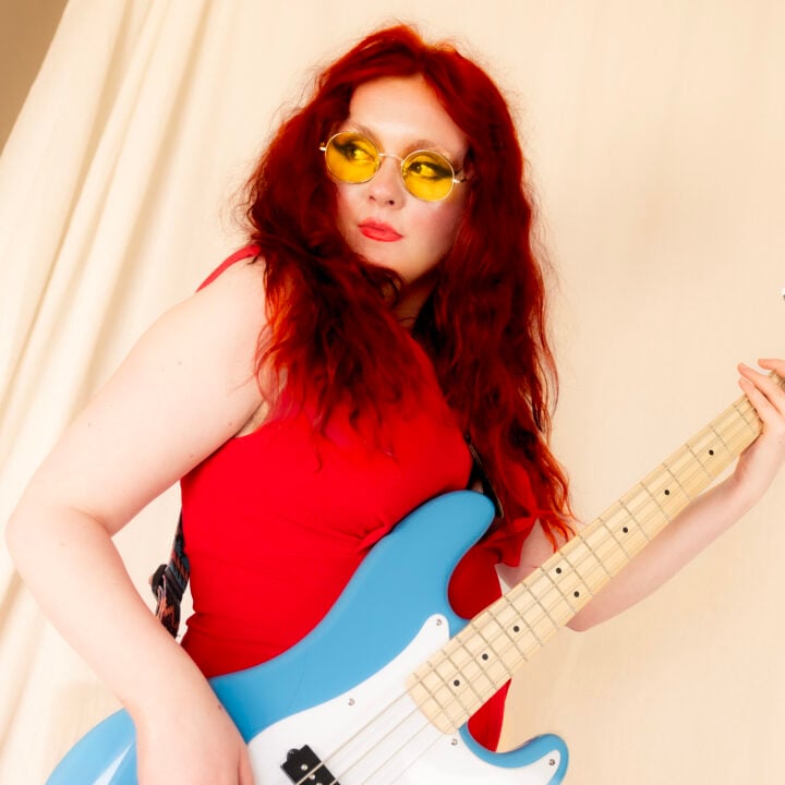 Women with long red hair playing guitar