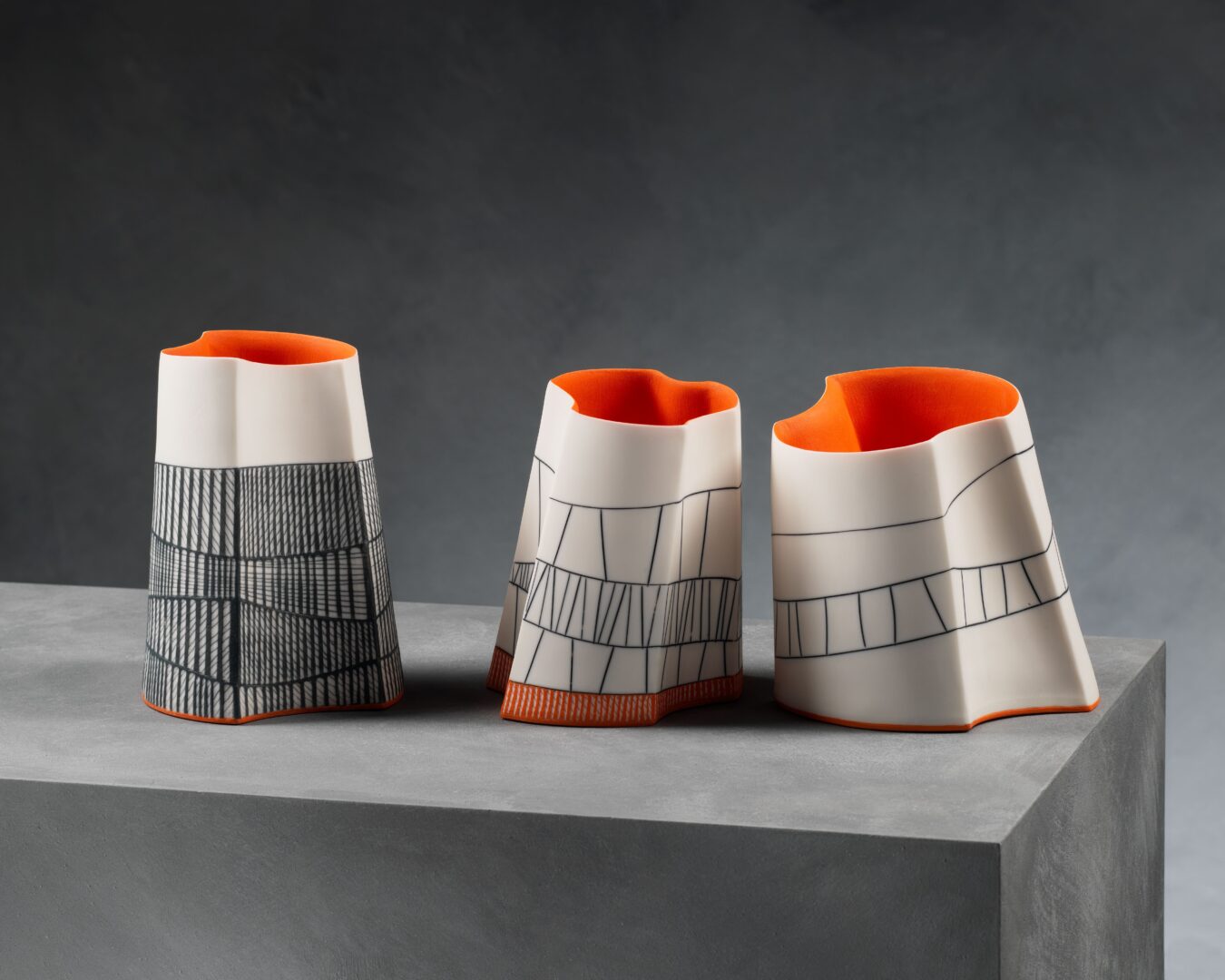 3 irregular shaped vases, decorated with line markings.