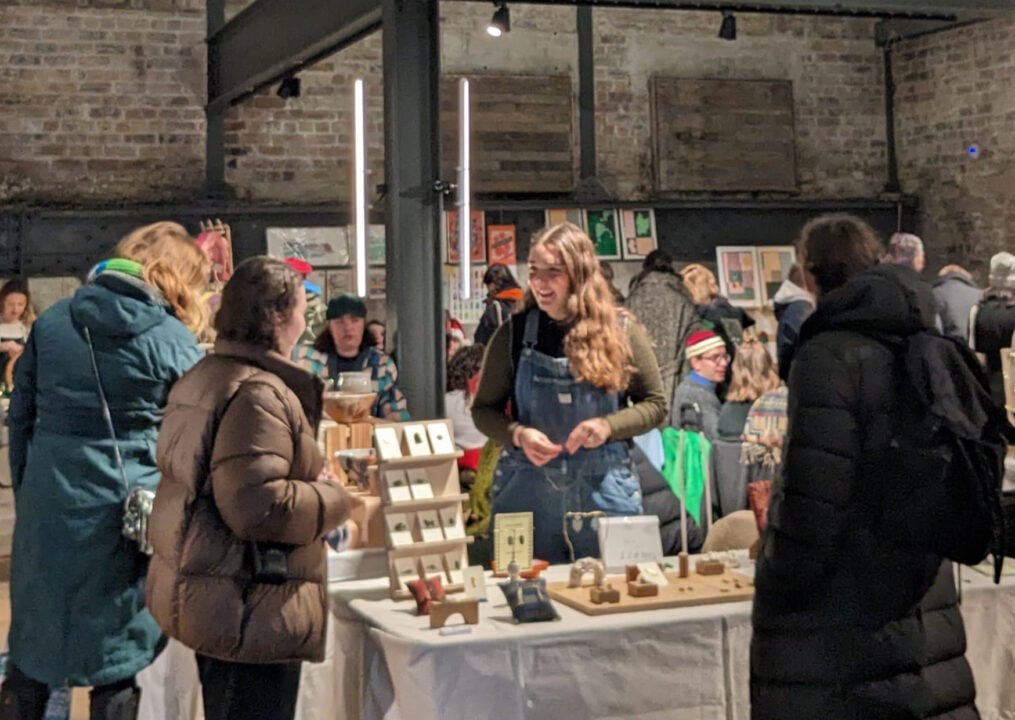 Room of people browsing stalls.