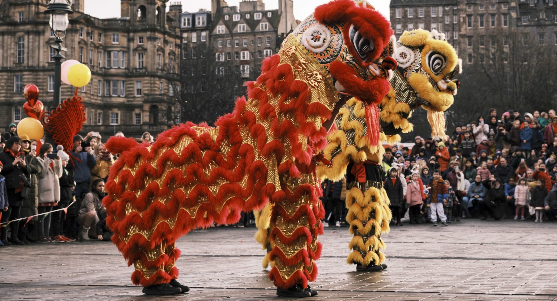 Participants at the Mound Precinct dressed up as huge ornate red and god and yellow and black Chinese dogs