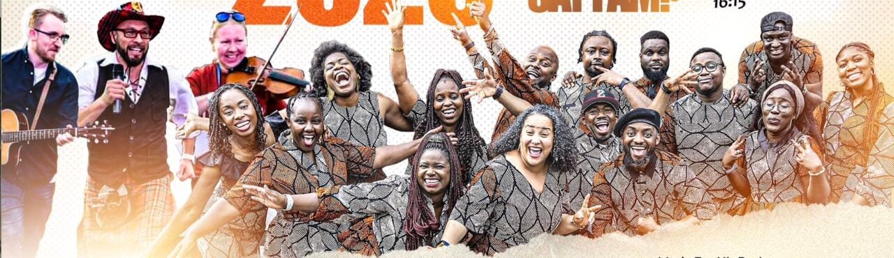 A group of of performers smiling and waving at the camera