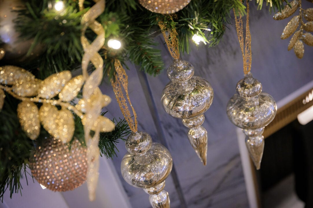 Close-up of silver and gold hanging decorations.