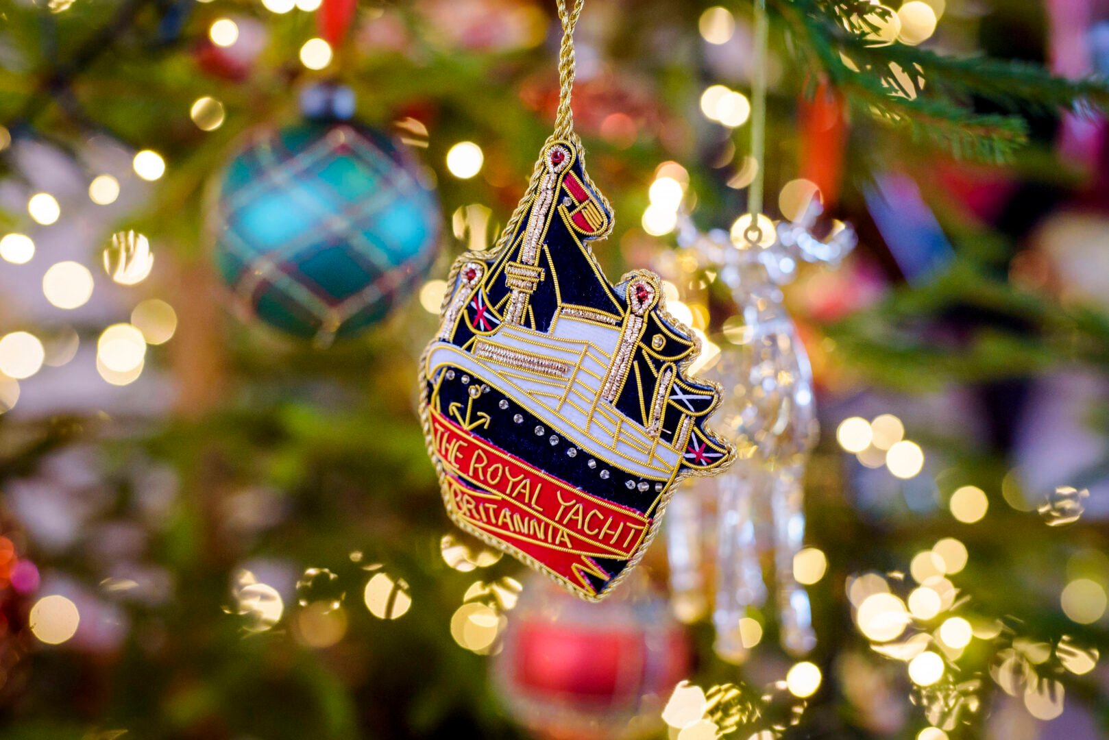 Fabric decoration of The Royal Yacht Britannia hanging on Christmas tree.