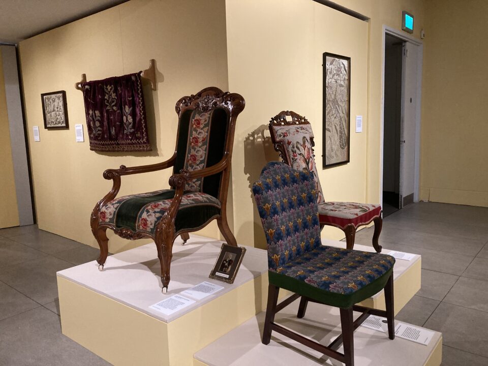 3 chairs with embroidered detail sitting on raised platforms.