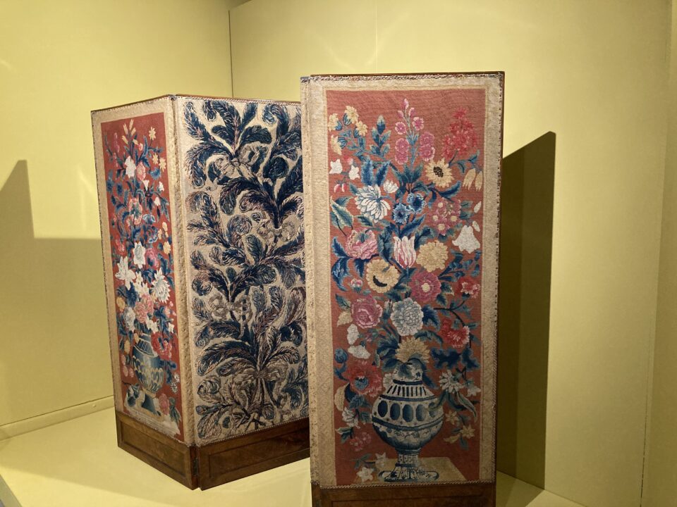 Room screen with embroidered panels.