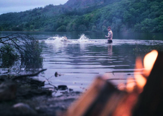 two people splashing in a loch