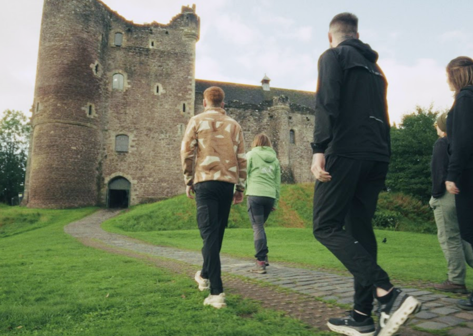 tour guide walking people towards castle