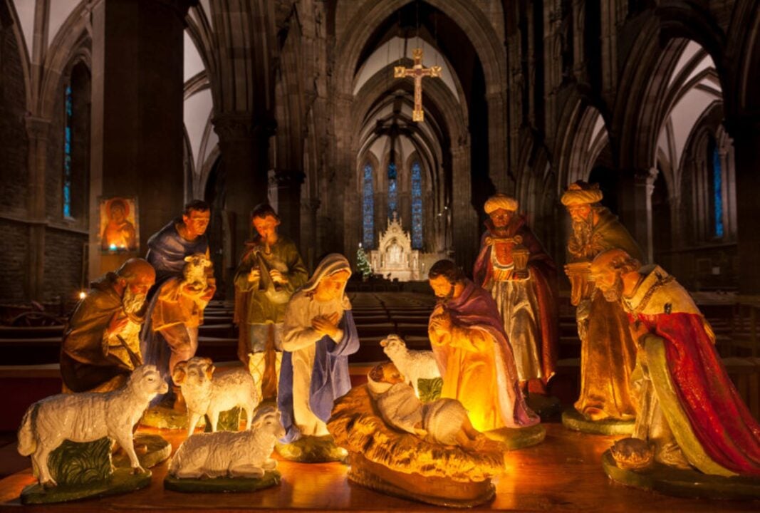 Nativity character statues crowded around baby jesus