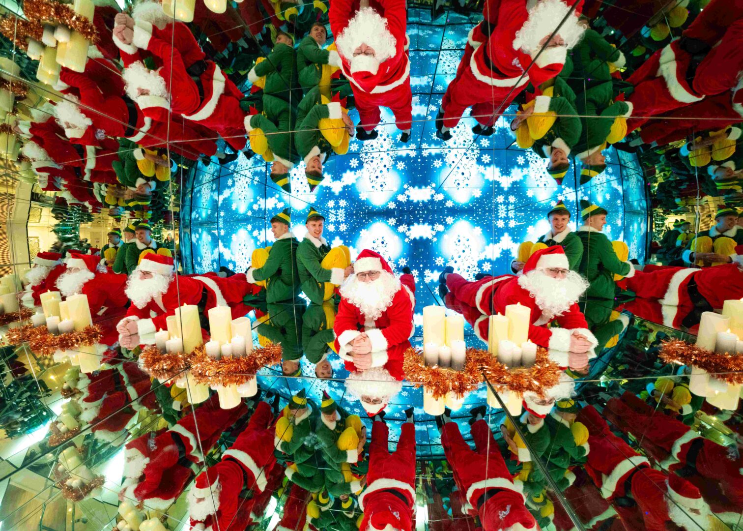 Mirrored image of Santa in a red and white costume, and an elf in an green and yellow costume.