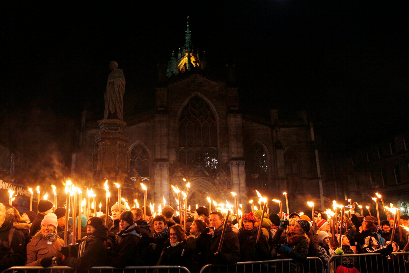 Crowd of people holding flaming torches.