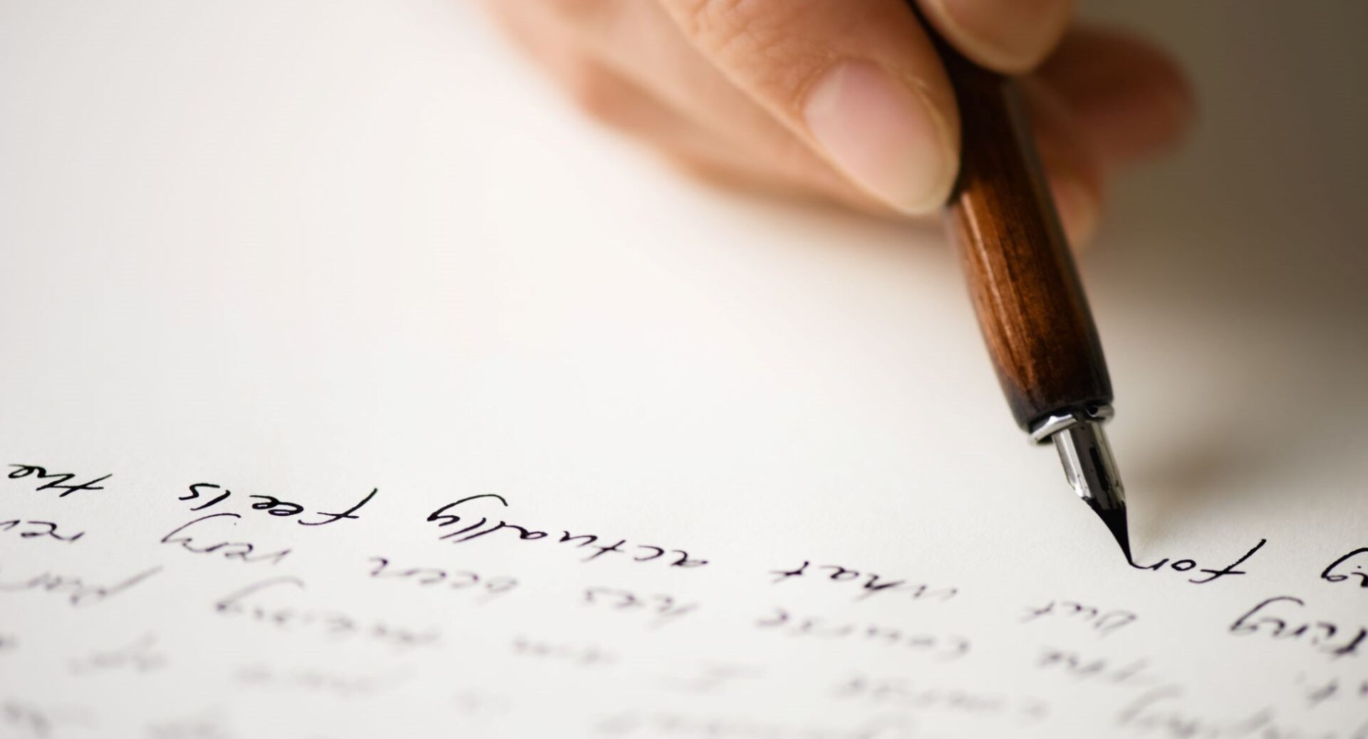 A hand writing on notepaper