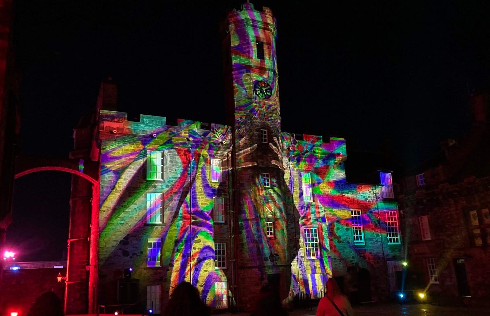 Castle of Light castle building with rainbow arms light projection